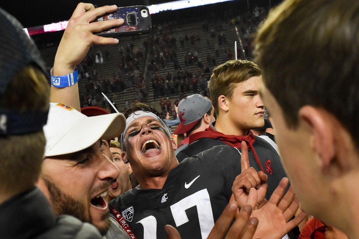 Washington State Cougars linebacker Peyton Pelluer (47) is mobbed by fans after defeating Oregon during the second half of a college football game on Saturday, October 20, 2018, at Martin Stadium in Pullman, Wash. WSU won the game 34-20. (Tyler Tjomsland / The Spokesman-Review)