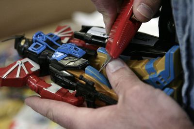A U.S. Customs and Border Protection  officer in Long Beach, Calif., scrapes a toy to determine if it’s painted or made of molded plastic. Toy retailers nationwide are scrambling to determine whether the toys on their shelves meet safety guidelines that take effect today.  (FILE Associated Press / The Spokesman-Review)