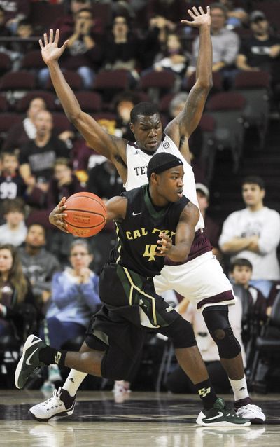 Cal Poly guard Jaylen Shead  dribbles around Texas A&M guard Jalen Jones during the second half on Tuesday, Dec. 29, 2015, in College Station, Texas. (Eric Christian Smith / AP)