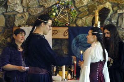 
Michael Stewart, second from left, reads his vows to Jaspenelle Stewart during their handfasting ceremony at Dishman Hills Natural Area in Spokane Valley last Saturday. The ceremony was a celebration of their love and commitment to each other. The couple was legally married in December 2004.  
 (Photos by Holly Pickett / The Spokesman-Review)