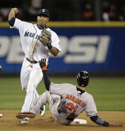 Seattle second baseman Jose Lopez throws to first base for a fifth-inning double play. Associated Press
(Associated Press / The Spokesman-Review)
