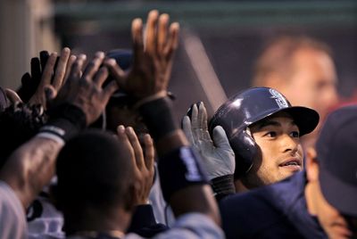 Ichiro Suzuki of the Mariners is congratulated after scoring in the third inning of Friday’s win.  (Associated Press / The Spokesman-Review)