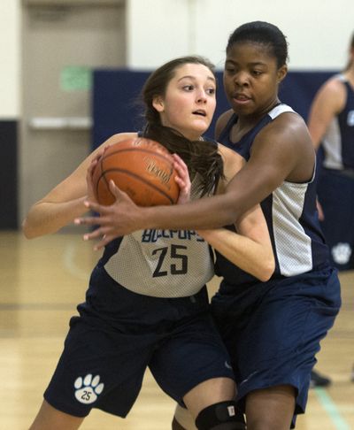 Molly McDermott, left, and Otiona Gildon battle in the paint during a Gonzaga Prep practice. (Jesse Tinsley)