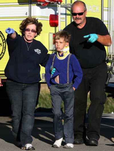 
Officials help a boy to an ambulance after he was  in a van crash  Sunday in Delaware County, Ind.Associated Press
 (Associated Press / The Spokesman-Review)