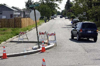 
A motorist heads east on Fairview Avenue off University Road in Spokane Valley on  Wednesday. Engineers have narrowed Fairview in response to new federal rules that govern railroad quiet zones. 
 (Liz Kishimoto / The Spokesman-Review)