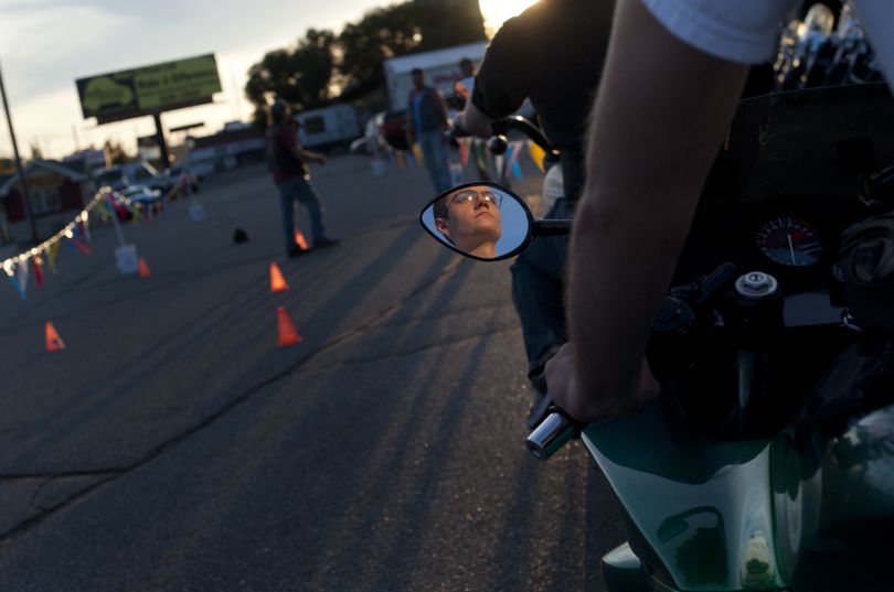 John White, 23, is seen reflected in the rearview mirror of his 1994 CBR 600 motorcycle before running through a low-speed obstacle course during Ride ’Em Wednesday this week at Empire Cycle and Powersports. (Tyler Tjomsland)