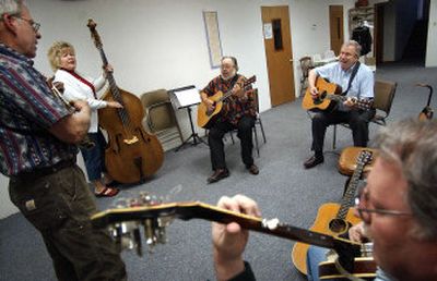 
From left, Greg Davis, Kathy Murbach, Dave Wright, Milt Asher and Chris Howie practice one of the songs on their playlist during a Bluegrass Conspiracy practice.
 (LIZ KISHIMOTO Photos / The Spokesman-Review)