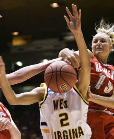 
West Virginia's Sparkle Davis is fouled by New Mexico's Amanda Adamson in the first half.Associated Press
 (Associated Press / The Spokesman-Review)