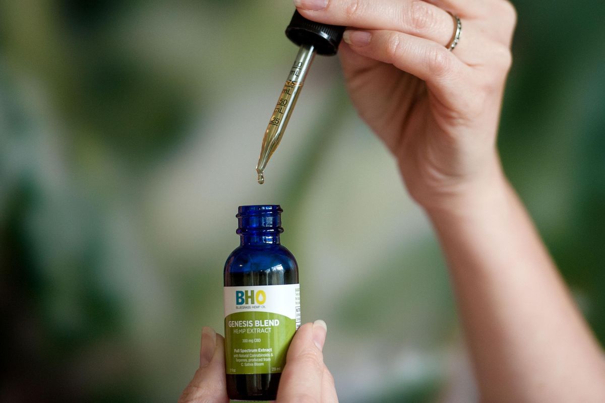 Jessica Charles of Bluegrass Hemp Oil demonstrates the dropper use of Genesis Blend hemp extract at the store in Spokane Valley on Tuesday, Jan. 8, 2019. (Kathy Plonka / The Spokesman-Review)
