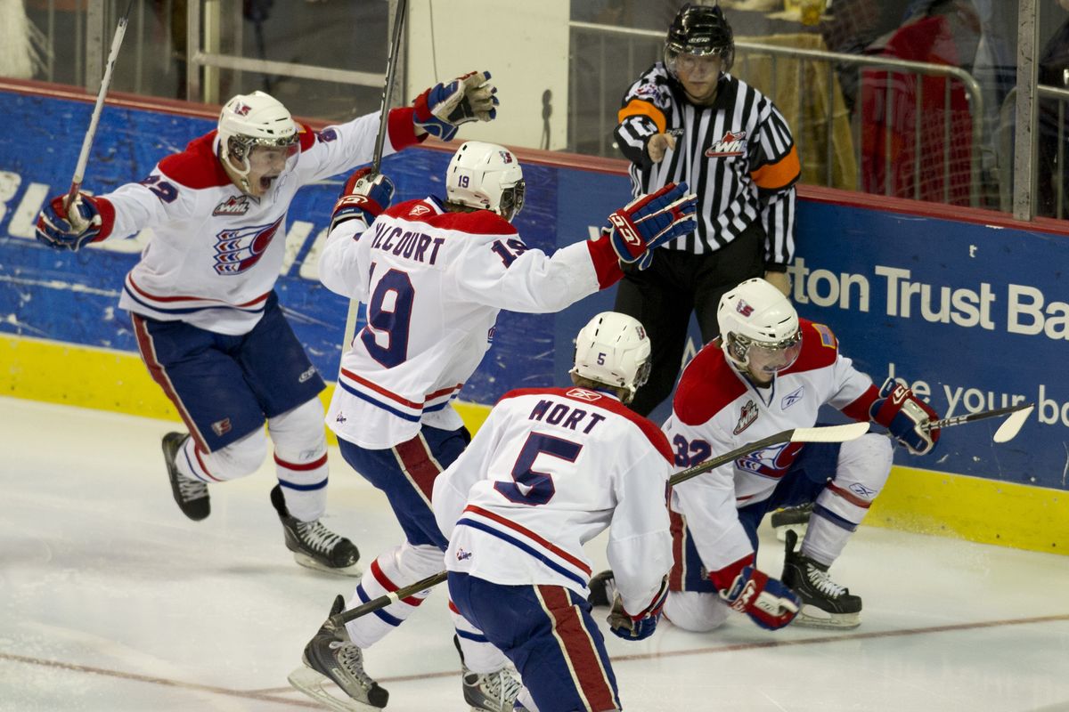 Spokane players celebrate a goal by Matt Marantz (32) 10 seconds into the game that jump-started the Chiefs’ 8-3 victory. (Colin Mulvany)