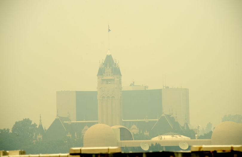 Heavy smoke from statewide forest fires blankets the Spokane County Courthouse on Friday.