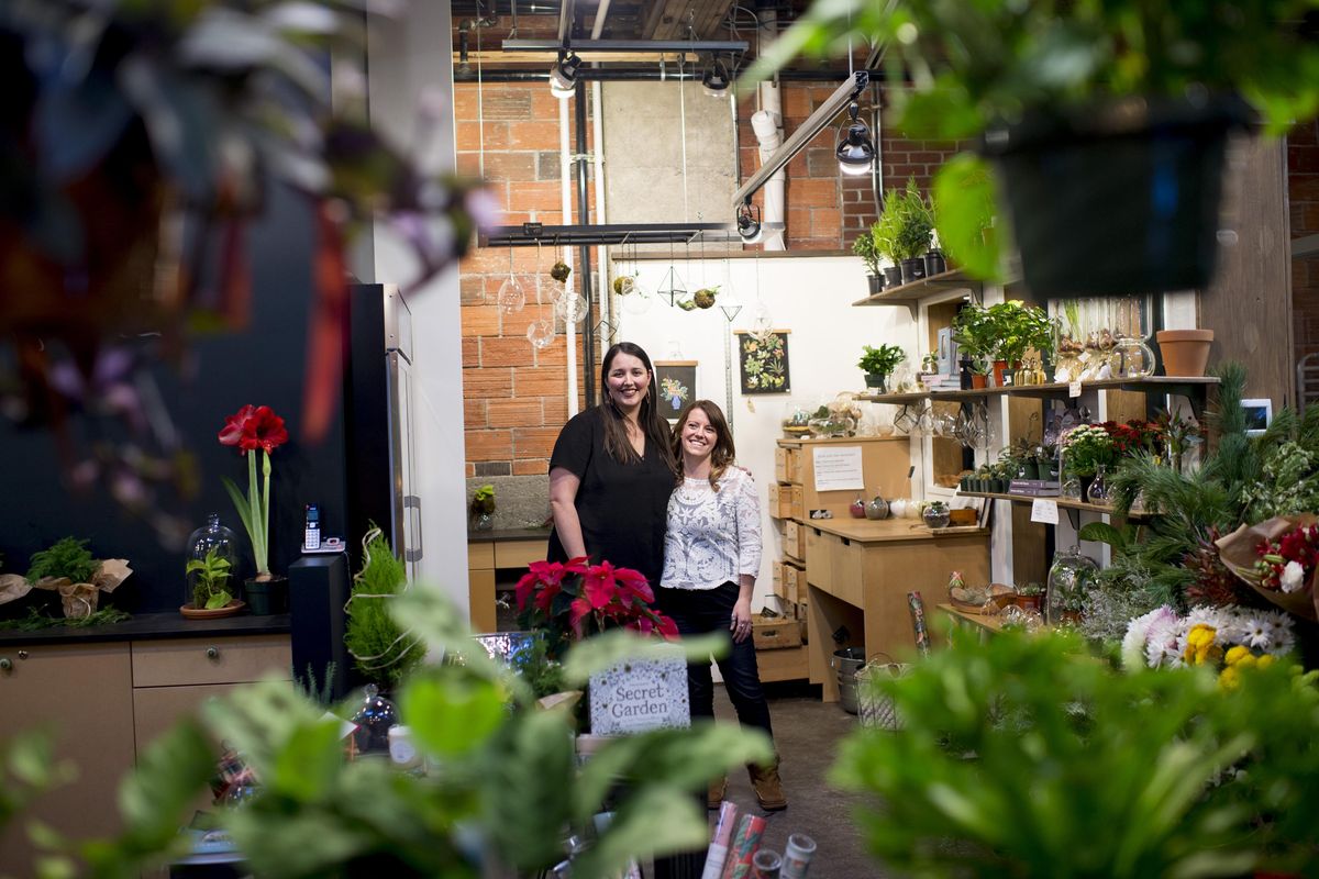 Parrish & Grove Botanicals owners Amanda Parrish left, and Chelsea Updegrove pose for a photo in their storefront on Tuesday, Dec. 13, 2016, at Saranac Commons in Spokane, Wash. (Tyler Tjomsland / The Spokesman-Review)