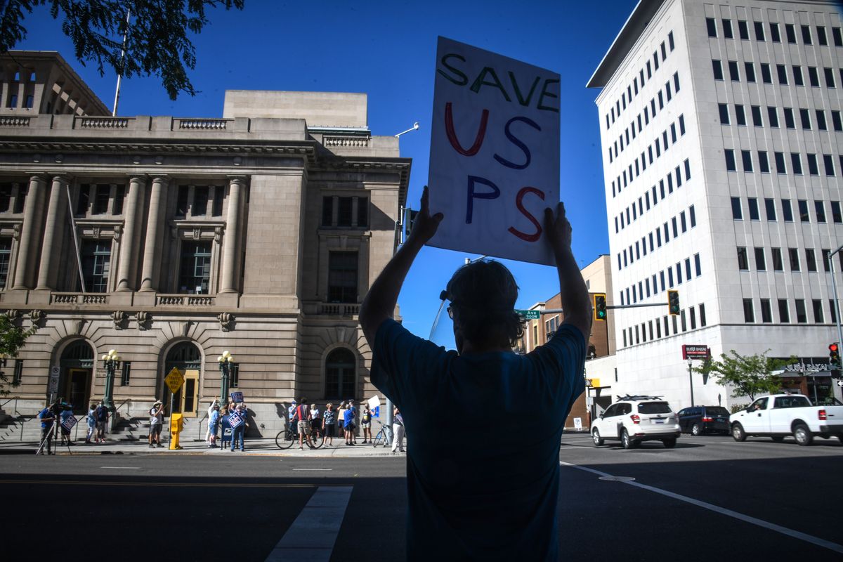 Tom Topping shows his support for the USPS during a demonstration, Tuesday, Aug. 25, 2020, at the corner of Riverside Avenue and Lincoln Street in Spokane.  (DAN PELLE/THE SPOKESMAN-REVIEW)