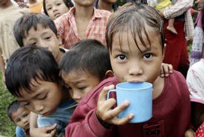 
Children line up to receive water from a local donor on the outskirts of Yangon, Myanmar, on Wednesday. Associated Press
 (Associated Press / The Spokesman-Review)
