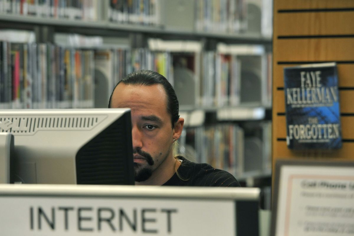 Craig Davis, 27, spends part of his afternoon Oct. 14  at the East Side Library using the Internet to gather job search information. The Spokane Library Board of Trustees is considering closing  the branch to save money.  (Dan Pelle)