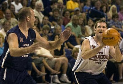
Ryan Floyd, right, grins as he shoots against his brother Colin.
 (Jed Conklin / The Spokesman-Review)