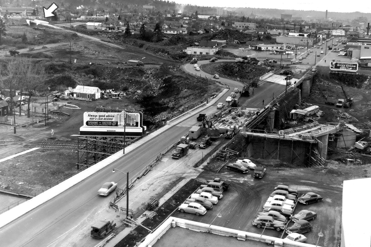 1953: East Sprague Avenue and Erie Street are part of the connection of Second and Third Avenue and the Sprague Avenue corridor. The photo taken from the Sperry Mill is looking west toward Spokane. Westbound cars will wind down under Sprague and proceed southwest to Second. East bound traffic on Third would come over the bridge marked by the arrow at upper left. The complex interchange relieved downtown traffic jams and moved east-west traffic quickly through town. The opening of Interstate 90 in the early 1970s took most of the traffic off the cutoff road.  (Spokesman-Review archives)