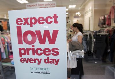 A shopper looks at clothing in a San Jose, Calif., mall on Tuesday. Clothing costs increased in July by the largest amount in a decade.   (Associated Press / The Spokesman-Review)