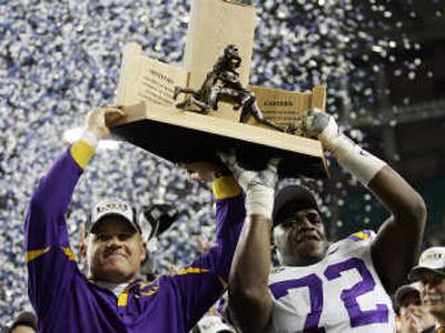 
LSU coach Les Miles, left, and tackle Glenn Dorsey show off the SEC championship trophy. Associated Press
 (Associated Press / The Spokesman-Review)