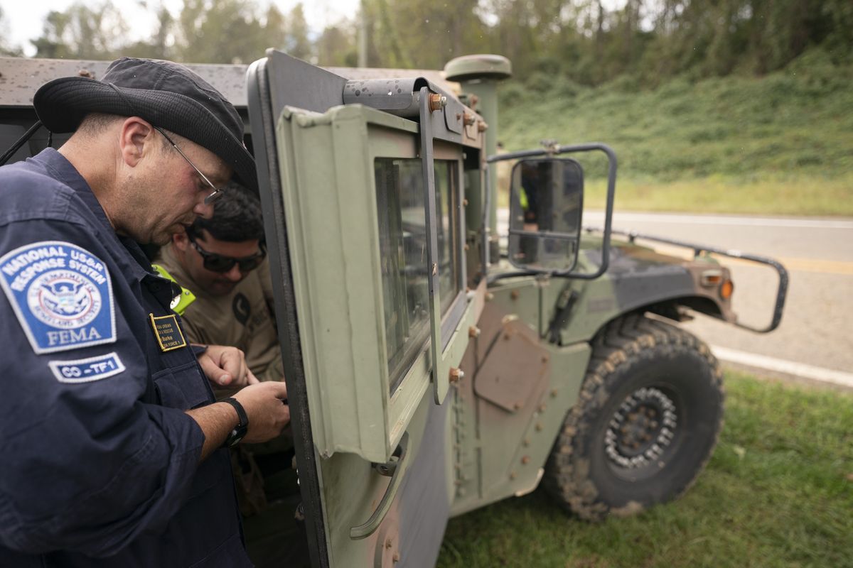 OLD FORT, NORTH CAROLINA - SEPTEMBER 30: A FEMA response team member works with a guard member at Crooked Creek Fire Department near Old Fort in the aftermath of Hurricane Helene on September 30, 2024 in Old Fort, North Carolina. The death toll has topped 100 people across the southeastern U.S., according to published reports. Millions are without power due to the storm, which made landfall as a Category 4 hurricane on Thursday. The White House has declared disasters in North Carolina, Florida, South Carolina, Tennessee, Georgia, Virginia and Alabama, freeing up federal emergency management money and resources for those states. (Photo by Sean Rayford/Getty Images)  (Sean Rayford)