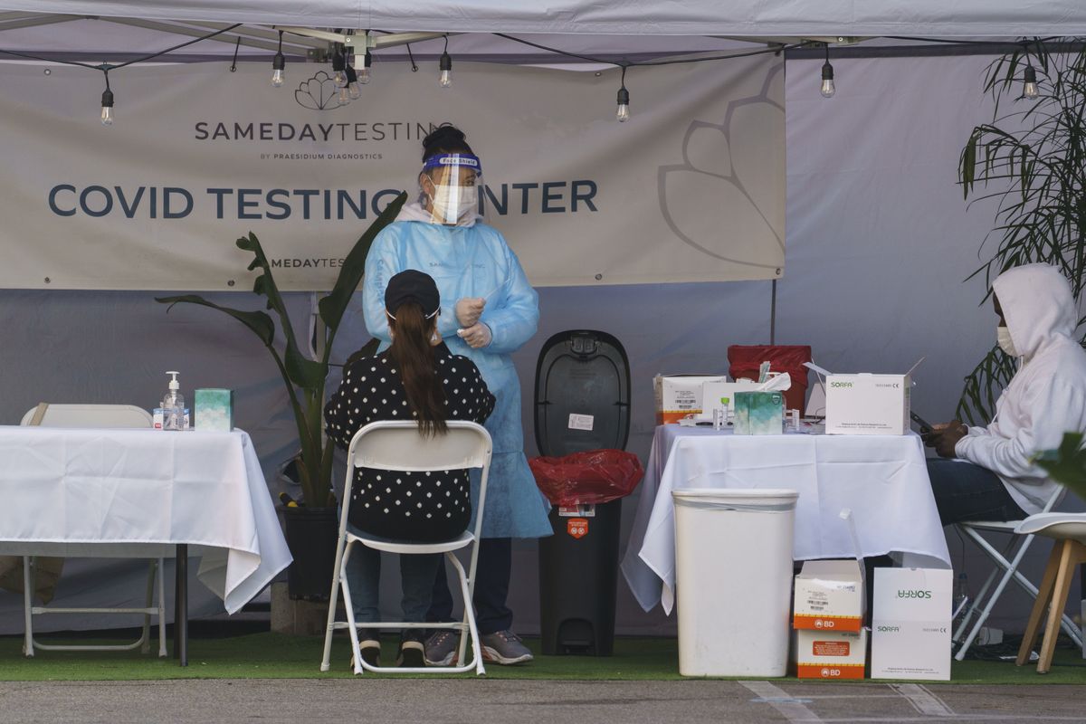 A mid-turbinate nasal swab PCR test is administered at a same-day coronavirus testing site in Los Angeles on Tuesday, Jan. 5, 2021. Los Angeles is the epicenter of California
