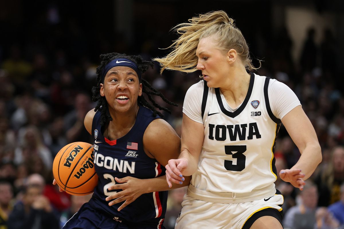 Connecticut’s KK Arnold, left, drives against Iowa’s Sydney Affolter at Rocket Mortgage Fieldhouse on Friday in Cleveland.  (Steph Chambers)