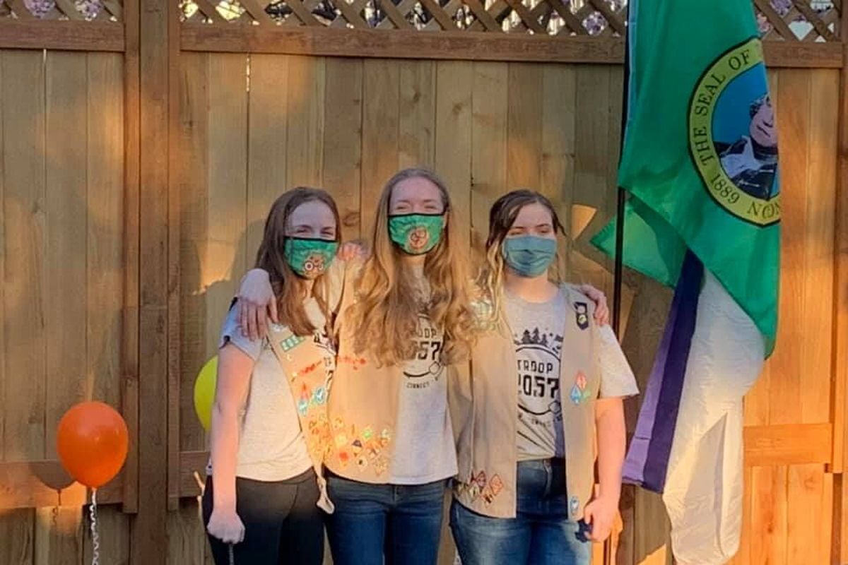 Elizabeth Ophardt, center, with her best friend, Lily Pasco, left, and her sister, Becca Ophardt, celebrate their advancement from cadettes to senior Scouts during a bridging ceremony last spring. They are the only senior members of Girl Scouts Troop 2057.  (Courtesy)