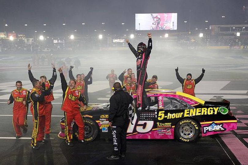 Clint Bowyer, driver of the #15 5-Hour Energy Benefiting Avon Foundation for Women Toyota, and his team celebrtate on the finishline after Bowyer won the NASCAR Sprint Cup Series Bank of America 500 at Charlotte Motor Speedway in Concord, North Carolina. (Photo by Tyler Barrick/Getty Images for NASCAR) (Tyler Barrick / Getty Images North America)