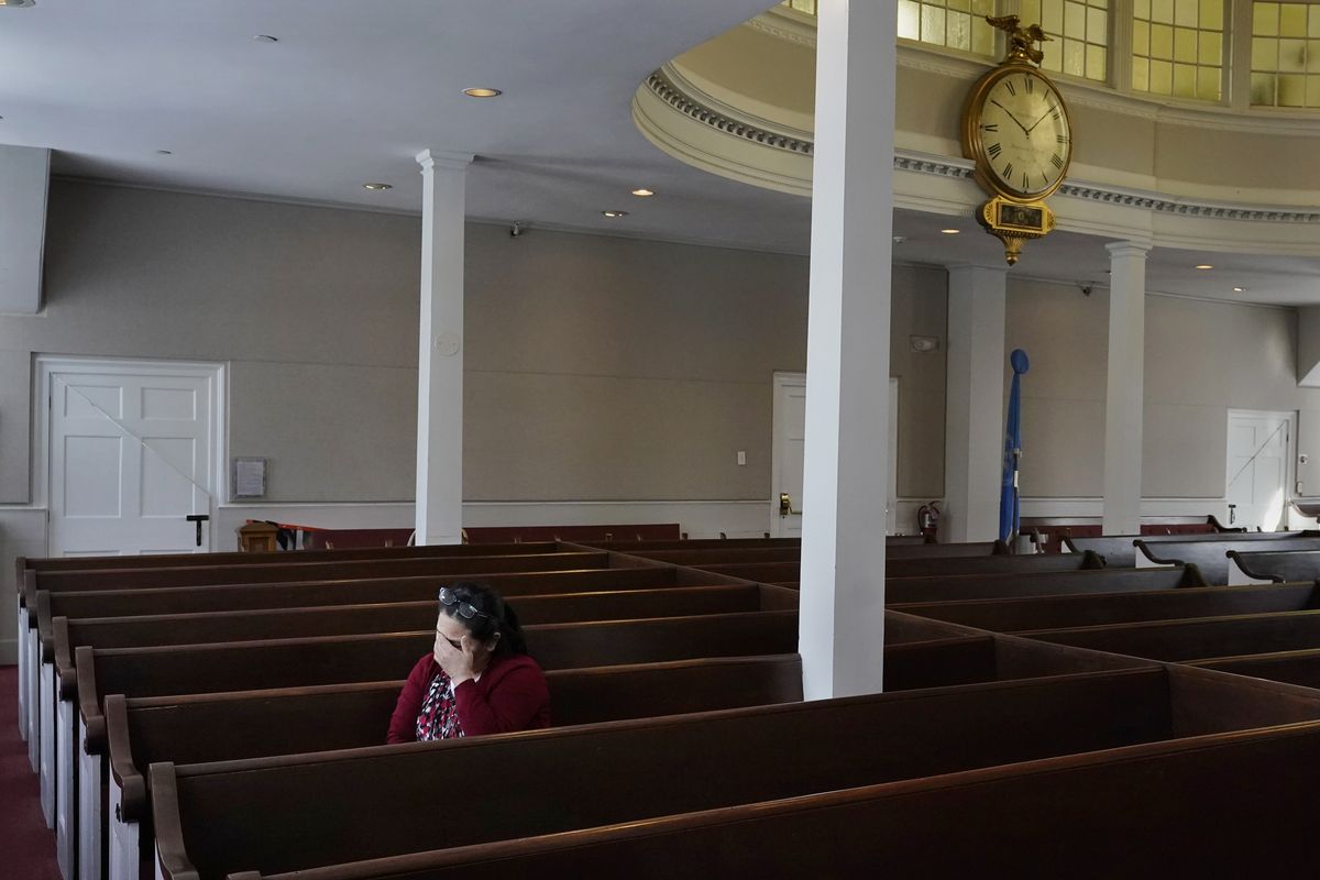 Maria Macario pauses as she talks about her family during an interview at the First Parish church, Friday, Jan. 29, 2021, in Bedford, Mass. For three years, Macario has been too afraid to leave the confines of the church, which she moved in to avoid deportation, spending most of her time in a converted Sunday school classroom stocked with a hot plate, mini-fridge, TV and single bed.  (Charles Krupa)