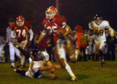
Sandpoint's Kurt Stoll avoids the lunge of Bishop Kelly's Sam Gray en route to the fourth-quarter touchdown that gave the Bulldogs a 20-14 lead. BK came back to win 21-20. 
 (Jesse Tinsley / The Spokesman-Review)