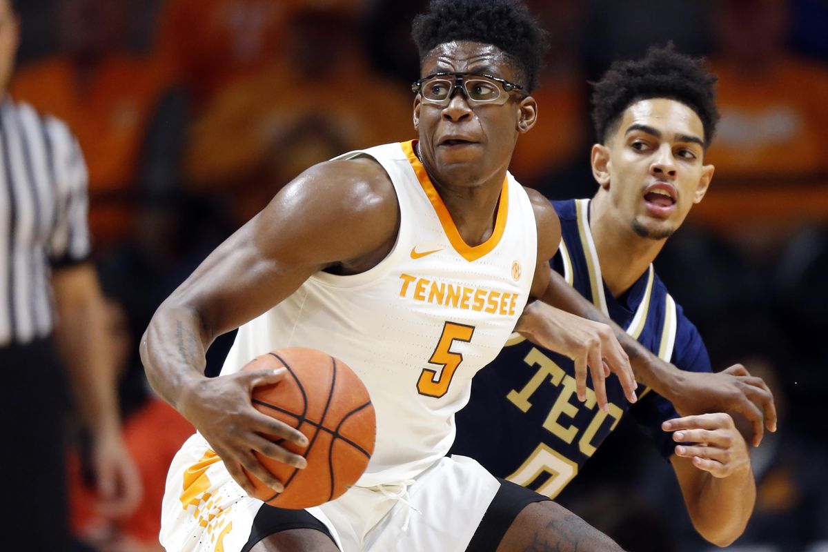 Tennessee guard Admiral Schofield  works against Georgia Tech guard Michael Devoe  during a November game. (WADE PAYNE / AP)