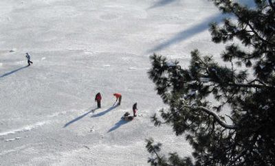 Robin Crain, Paul Ramsey and Austin Trumpour of Spokane go ice fishing for trout on Hog Canyon Lake.
(Photos by Rich Landers/ / The Spokesman-Review)