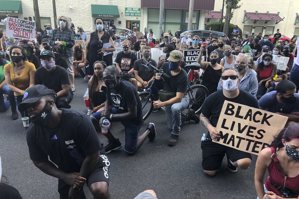 Protesters kneel in front of the Lehigh County Jail in Allentown, Pa., on Monday to demonstrate against police brutality after video emerged of an officer placing his knee on a man’s head and neck area outside a city hospital.  (Michael Rubinkam)
