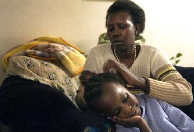 Akon Eliow, 5, sits patiently while her mother, Akout Agang, braids her hair at their apartment in Spokane. Akout and her husband, Georges Eliow, both Sudanese refugees, are still waiting for their 11-year-old son, Eliow, to get clearance to join them in the United States.
(Holly Pickett / The Spokesman-Review)