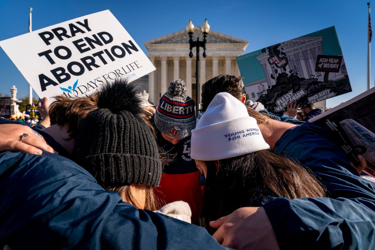 FILE - A group of anti-abortion protesters pray together in front of the U.S. Supreme Court, Dec. 1, 2021, in Washington, as the court hears arguments in a case from Mississippi, where a 2018 law would ban abortions after 15 weeks of pregnancy, well before viability. As the Supreme Court court weighs the future of the landmark 1973 Roe v. Wade decision, a resurgent anti-abortion movement is looking to press its advantage in state-by-state battles while abortion-rights supporters prepare to play defense.  (Andrew Harnik)