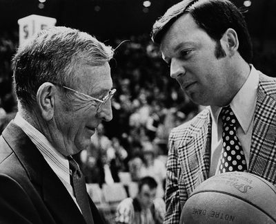 In this Jan. 27, 1973 photo, UCLA basketball coach John Wooden, left, accepts the game ball from Notre Dame coach Digger Phelps after UCLA set a new consecutive winning streak of 61 games by beating Notre Dame 82-63 in South Bend, Ind. Digger Phelps and John Wooden on the sidelines. In those days, Notre Dame vs. UCLA in basketball was one of the sports greatest rivalries. (Associated Press)