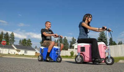 
Logan Chichester, 19, left, and Kalina Griggs, 19, ride their Cruzin Coolers around their north Coeur d'Alene neighborhood.
 (Jesse Tinsley / The Spokesman-Review)