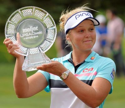 Brooke Henderson poses with the trophy after winning the Meijer LPGA Classic on Sunday. (Cory Olsen / Associated Press)