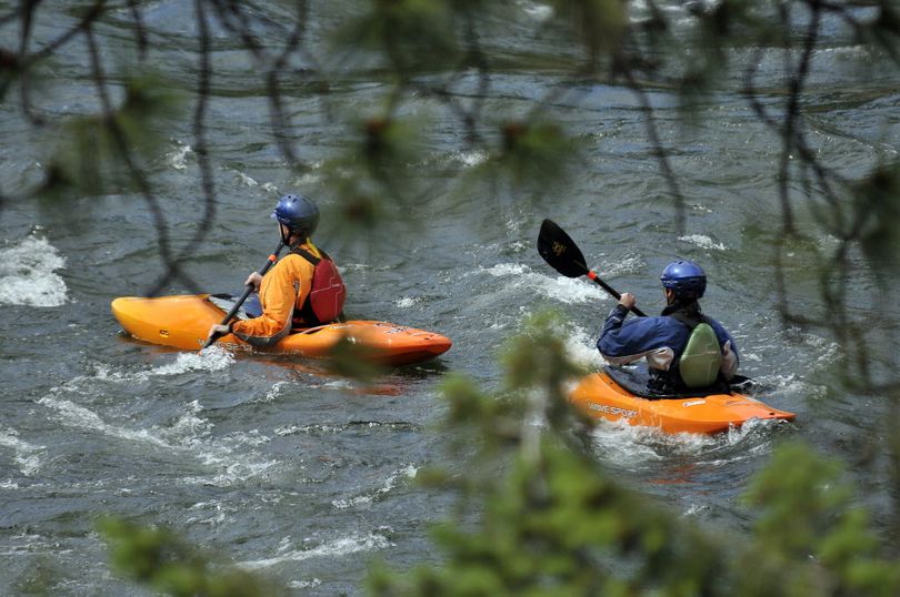 Experienced kayakers paddle in teams on spring run-off rivers and wear top-of-the line life vests and dry suits for protection from the cold water. (Jesse Tinsley)