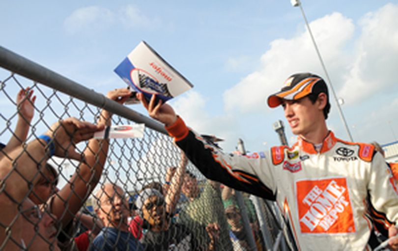 Joey Logano takes time to sign autographs for fans between the two Nationwide Series practices at Kentucky Speedway. (Photo Credit: Dak Dillon for NASCAR)  (The Spokesman-Review)