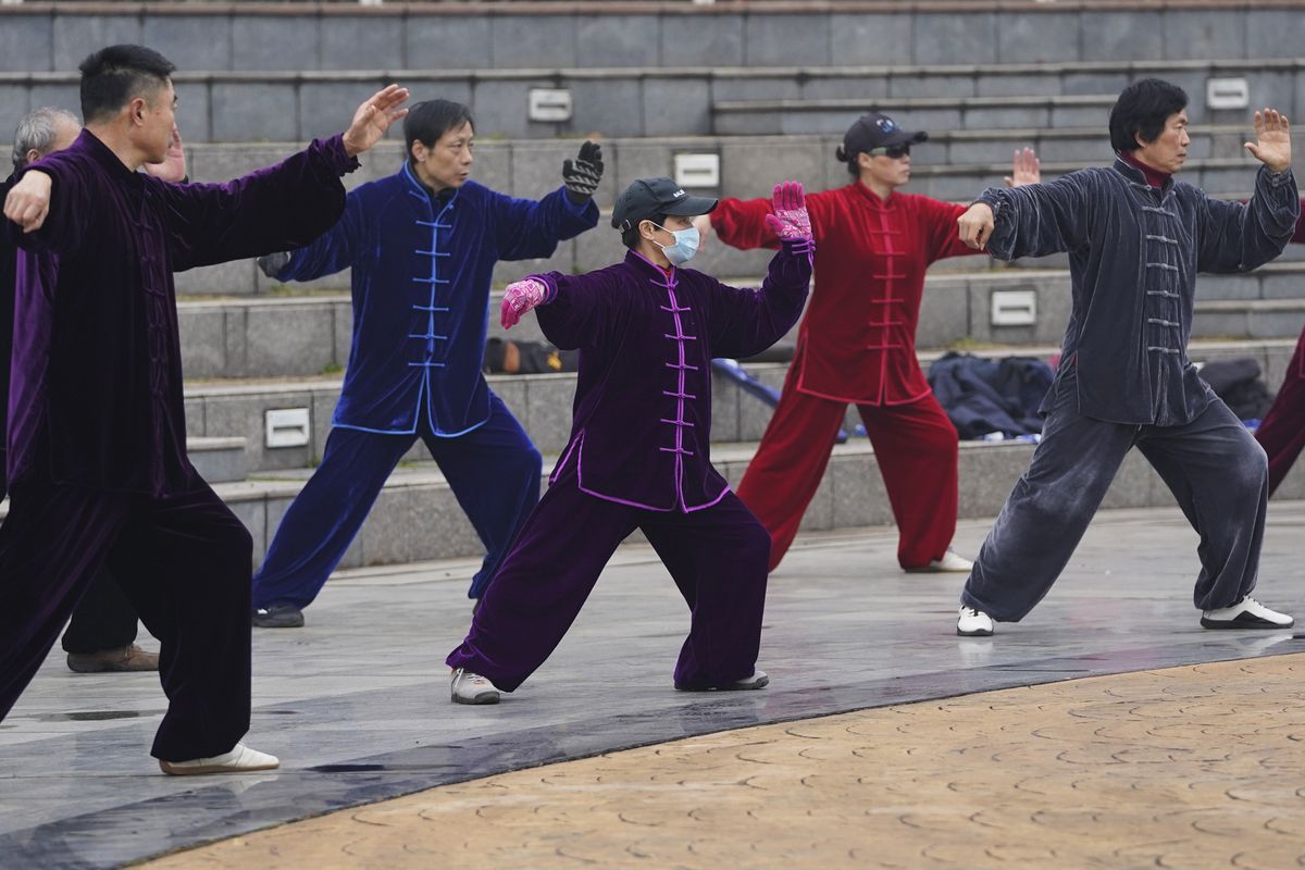 Residents practice tai chi at a park Saturday in Wuhan in central China’s Hubei Province.  (Ng Han Guan)