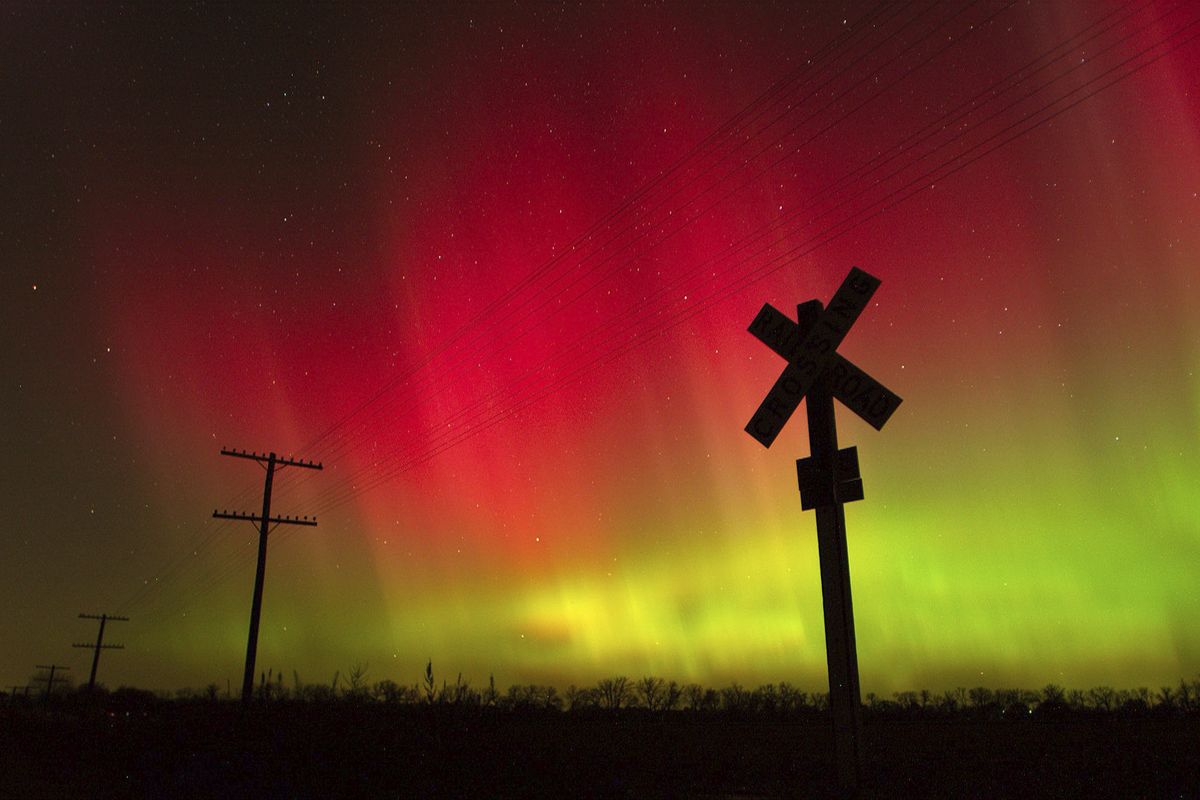 FILE - In this Nov. 8, 2004, file photo, the aurora borealis lights up the sky northwest of Lawrence, Kan. The phenomenon, also called northern lights, occurs when electrically charged particles from the sun enter the earth