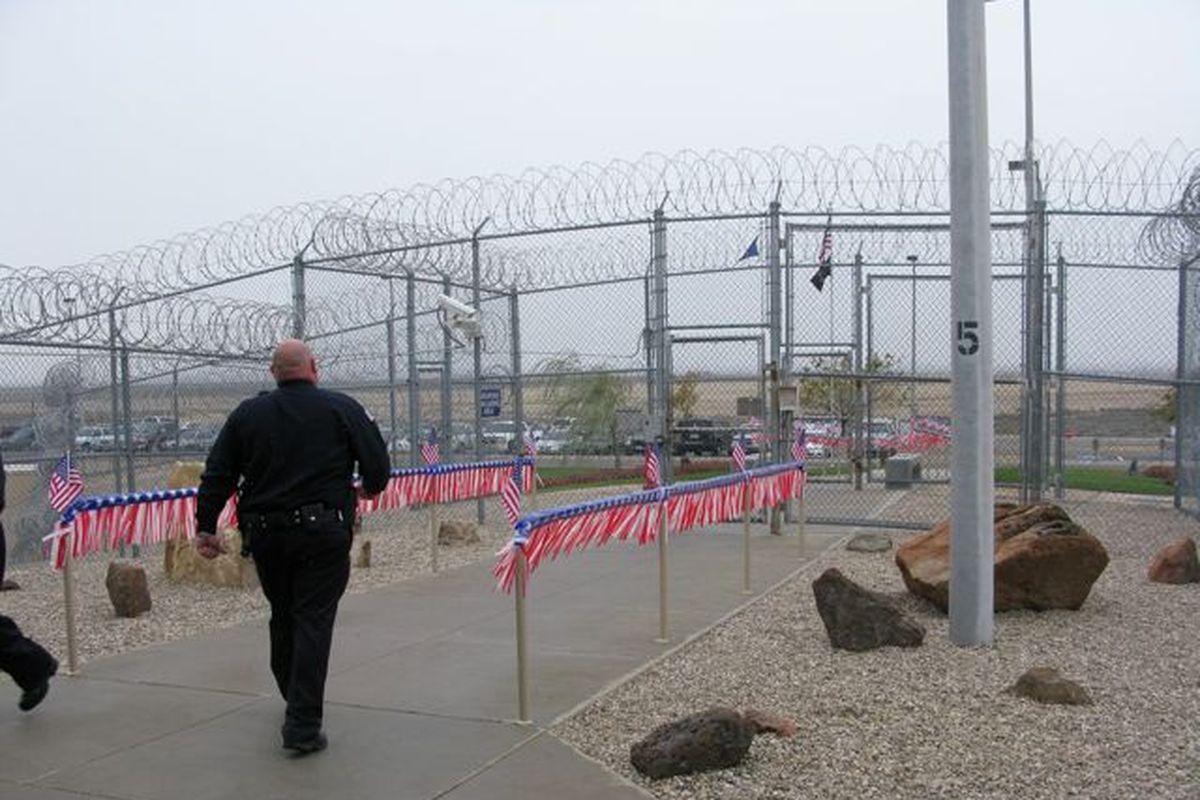 A correctional officer leaves the Idaho Maximum Security Institution, whose entryway was festooned with flags on Thursday to mark the prison