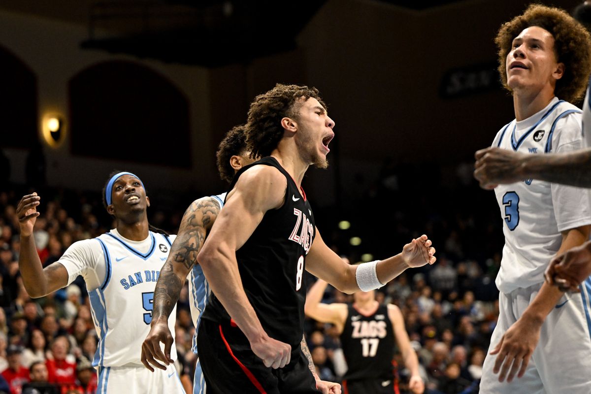 Gonzaga Bulldogs guard Jalen Warley (8) cheers after he drew a foul late as San Diego Toreros guard Ty-Laur Johnson (5) and forward Darrae Goodwin (3) react during the second half of a college basketball game on Tuesday, Dec 30, 2025, at Jenny Craig Pavilion in San Diego, Calif. The Gonzaga Bulldogs won the game 99-93.  (Tyler Tjomsland/The Spokesman-Review)