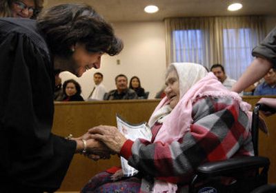 
U.S. Magistrate Judge Cynthia Imbrogno congratulates Nadezhda Ivanova Deynega, after the 99-year-old Russian woman received her Certificate of Naturalization on Thursday in the downtown Spokane post office. 
 (Dan Pelle / The Spokesman-Review)
