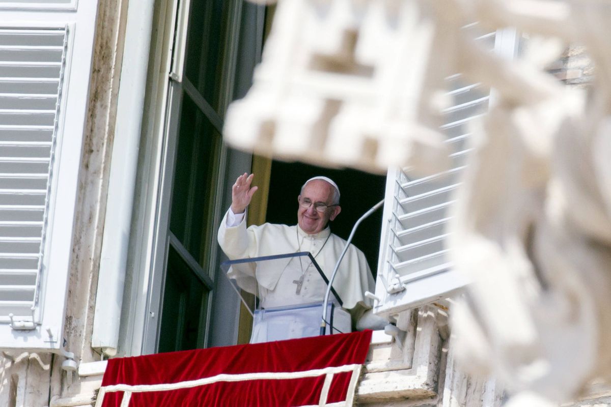 Pope Francis waves to faithful from his studio window overlooking St. Peter’s Square at the Vatican on Sunday. (Associated Press)