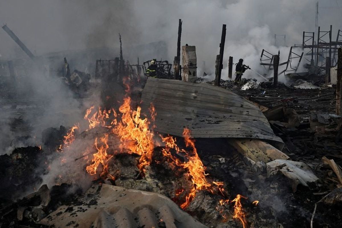 Emergency responders work at the site of a warehouse that was struck during a night of Russian missile and drone strikes, amid Russia’s attack on Ukraine, in Novi Petrivtsi, on Dec. 6, outside Kyiv, Ukraine.  (Thomas Peter/Reuters)