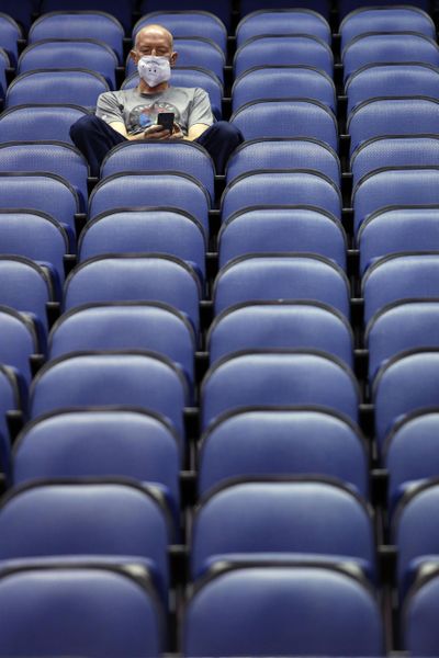 Mike Lemcke, from Richmond, Va., sits in an empty Greensboro Coliseum after the NCAA college basketball games were canceled at the Atlantic Coast Conference tournament in Greensboro, N.C., Thursday, March 12, 2020. (Ben McKeown / AP)
