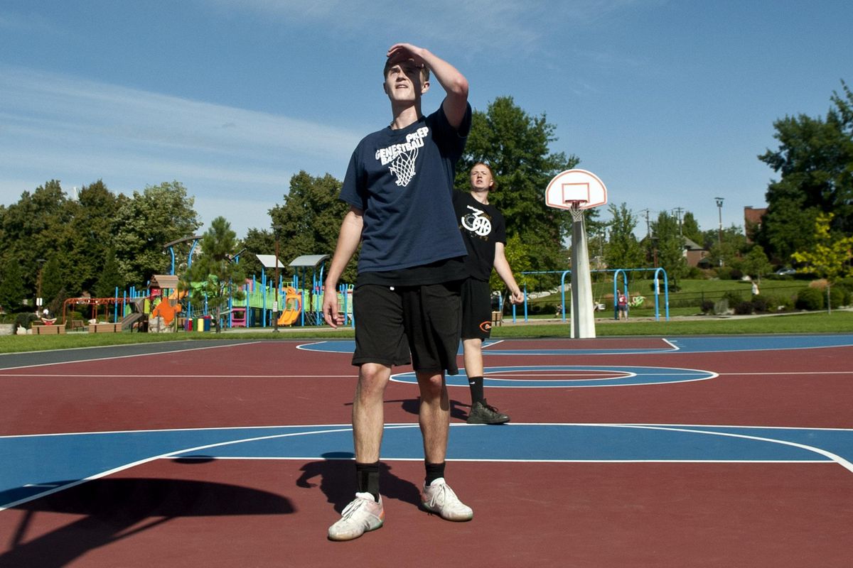 Genesis Prep Academy senior Jacob Peterson, front watches the basket during a game against sophomore Tristan Snowder during the "Kix For Kids" fundraiser at McEuen Park in Coeur d'Alene on Saturday, Aug. 24, 2019. (Kathy Plonka / The Spokesman-Review)