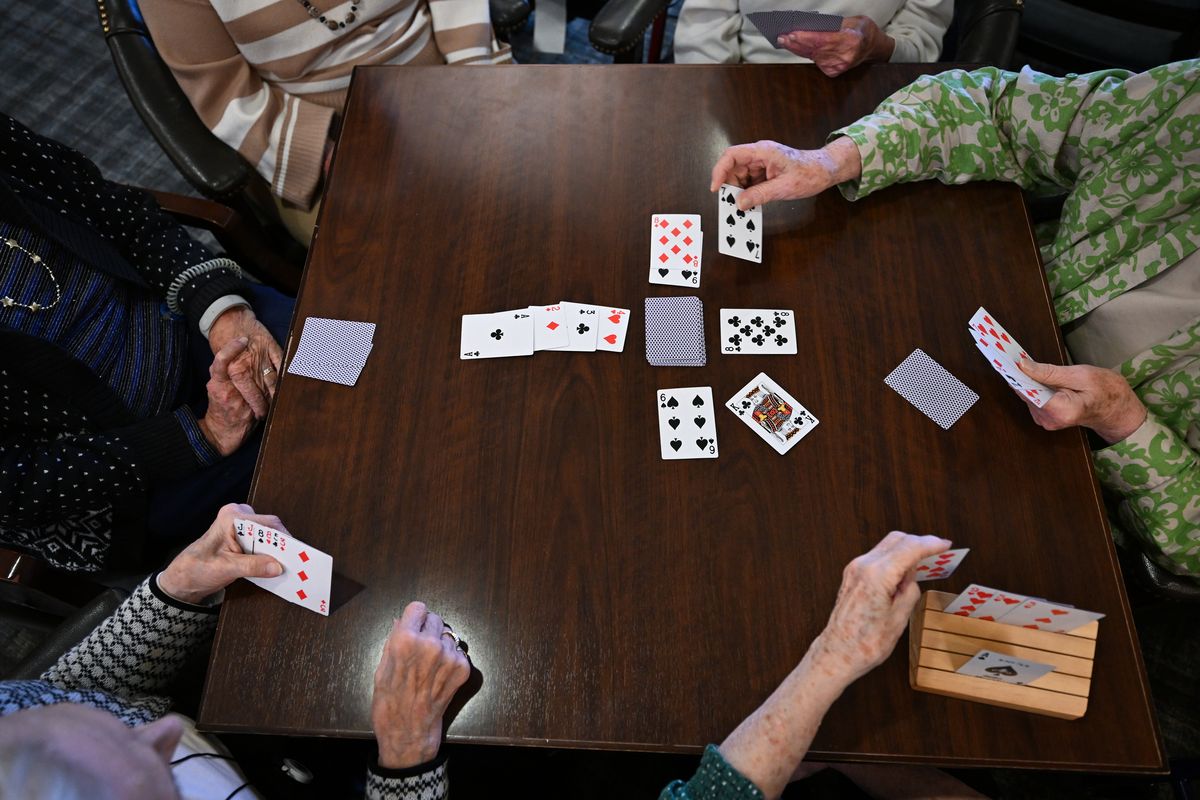 Assisted-living residents play cards after getting their manicures.  (Matt McClain/Washington Post)